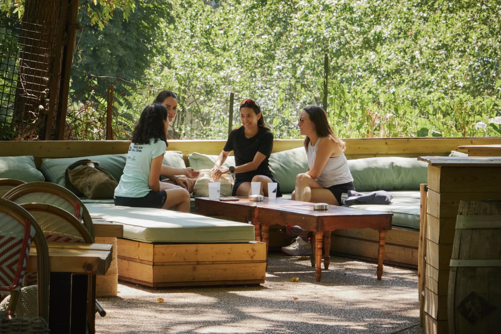 Three people talking on a terrace after the workout