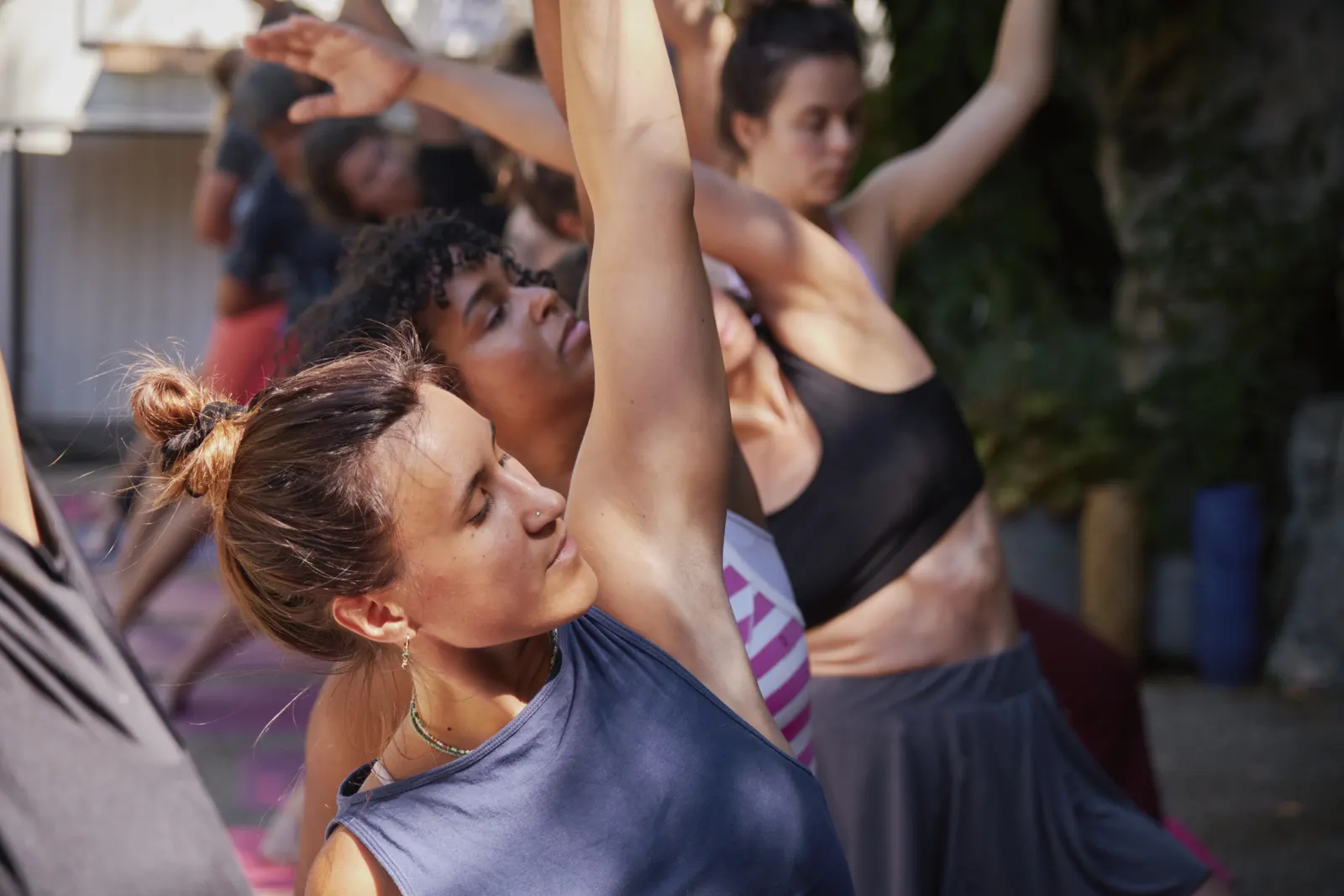 Outdoor yoga class, arms up